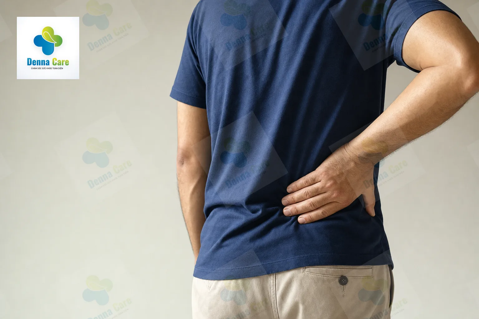 Người trung niên ôm vùng đau lưng dưới với vẻ khó chịu